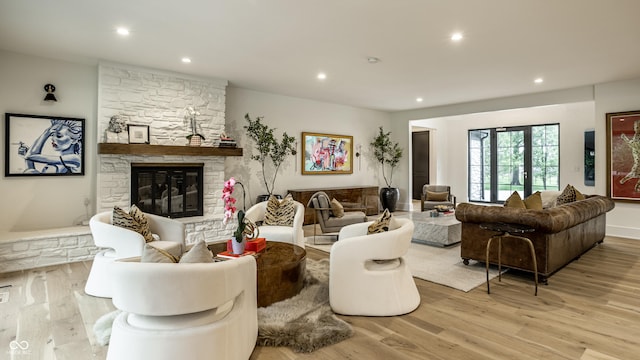 3549 W 131st St, Carmel, IN 46032 - living room with light wood-style flooring, a stone fireplace, and recessed lighting