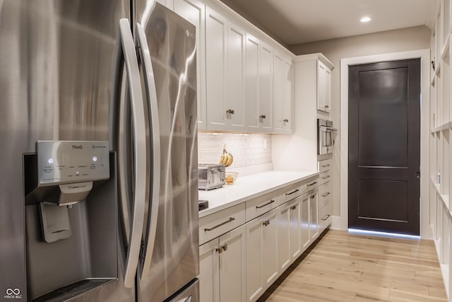 3549 W 131st St, Carmel, IN 46032 - kitchen featuring freestanding refrigerator, light wood finished floors, white cabinetry, tasteful backsplash, and light countertops