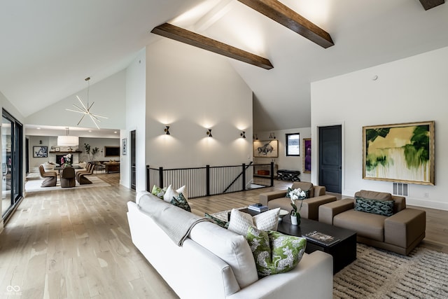 3549 W 131st St, Carmel, IN 46032 - living room featuring high vaulted ceiling, light wood-style flooring, beamed ceiling, and a chandelier