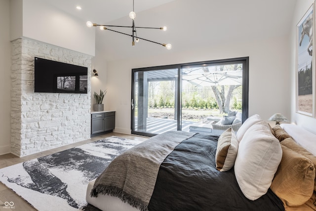 3549 W 131st St, Carmel, IN 46032 - bedroom featuring access to exterior, a chandelier, high vaulted ceiling, and light wood-type flooring