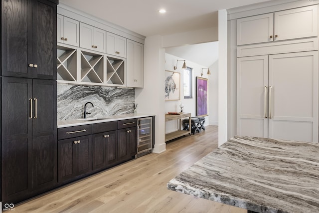 3549 W 131st St, Carmel, IN 46032 - indoor wet bar with beverage cooler, backsplash, light wood-type flooring, paneled fridge, and recessed lighting