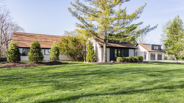 3549 W 131st St, Carmel, IN 46032 - back of property with a lawn, concrete driveway, and an attached garage