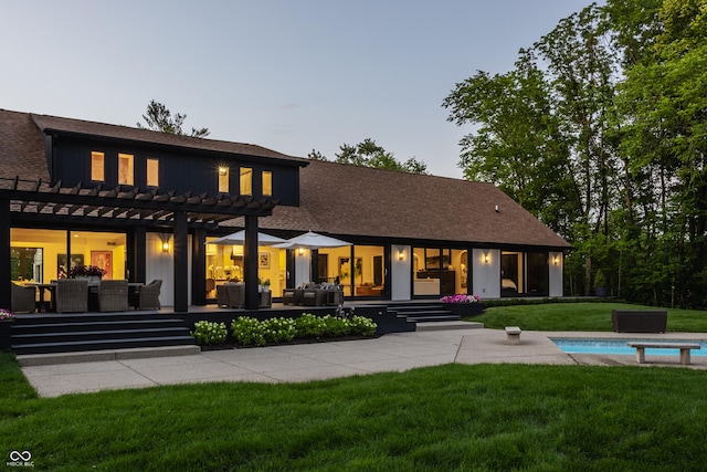 3549 W 131st St, Carmel, IN 46032 - back of house with an outdoor hangout area, a pergola, an outdoor pool, a lawn, and roof with shingles