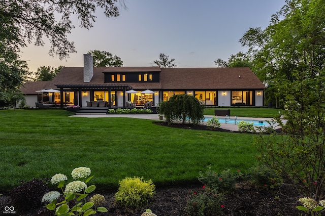 3549 W 131st St, Carmel, IN 46032 - back of property at dusk featuring a chimney and a yard