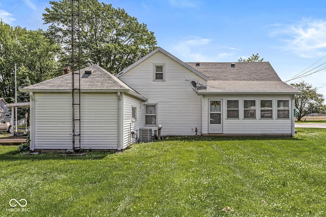 9290 Vine St, Manilla, IN 46150 - rear view of house featuring a lawn, a shingled roof, and central air condition unit