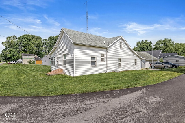 9290 Vine St, Manilla, IN 46150 - view of side of property with roof with shingles and a lawn
