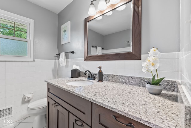 1010 Maple St, Greenwood, IN 46142 - full bath featuring vanity, tile walls, tile patterned flooring, and wainscoting