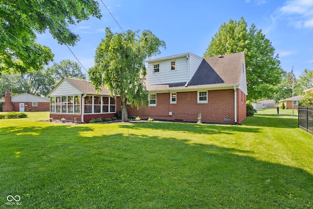 1010 Maple St, Greenwood, IN 46142 - back of property featuring a sunroom, a yard, brick siding, and crawl space