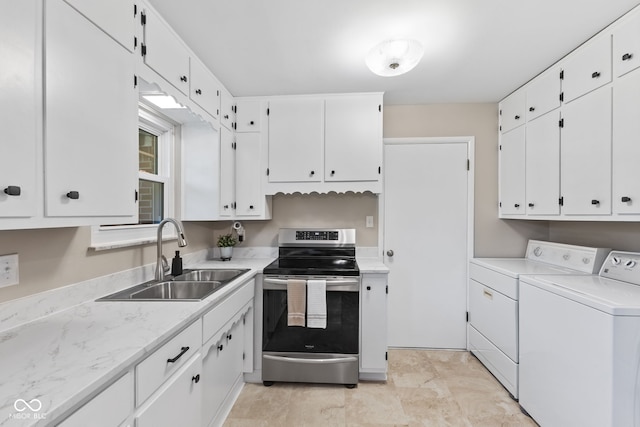 1010 Maple St, Greenwood, IN 46142 - kitchen featuring stainless steel electric range oven, washing machine and dryer, white cabinets, and light countertops
