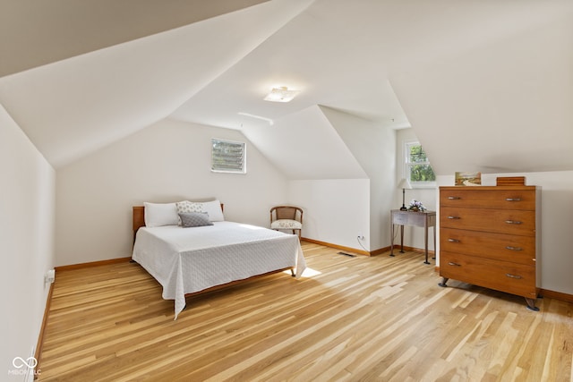 1010 Maple St, Greenwood, IN 46142 - bedroom featuring multiple windows, light wood-style floors, and vaulted ceiling