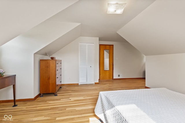 1010 Maple St, Greenwood, IN 46142 - bedroom featuring light wood-style floors, lofted ceiling, and a closet