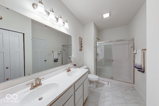 59 Manchester Dr, Trafalgar, IN 46181 - bathroom featuring marble finish flooring, double vanity, a stall shower, toilet, and baseboards