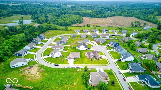 59 Manchester Dr, Trafalgar, IN 46181 - aerial view of residential area with a heavily wooded area and a large body of water