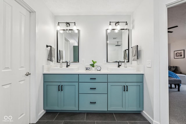 1345 Lewiston Dr, Westfield, IN 46074 - full bathroom featuring ensuite bath, double vanity, a textured ceiling, and tile patterned flooring