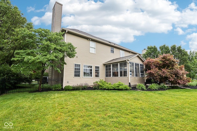 1345 Lewiston Dr, Westfield, IN 46074 - rear view of property with a sunroom and a chimney