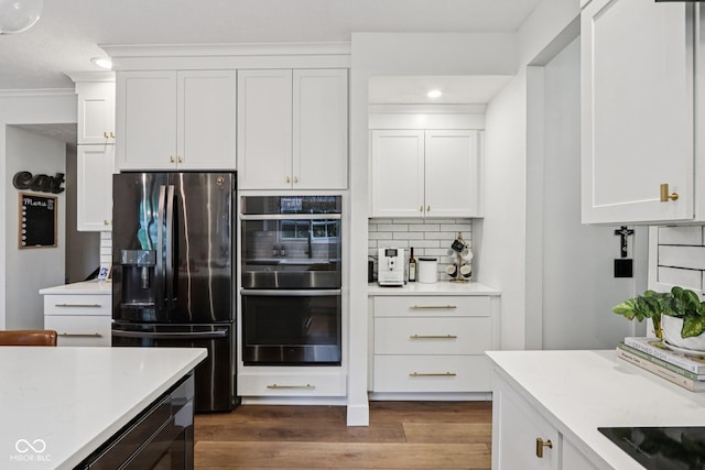 1345 Lewiston Dr, Westfield, IN 46074 - kitchen with appliances with stainless steel finishes, tasteful backsplash, white cabinetry, dark wood-style flooring, and recessed lighting
