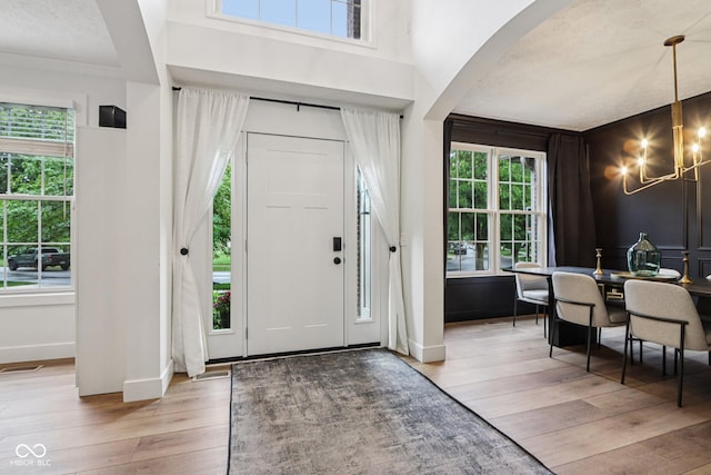 1345 Lewiston Dr, Westfield, IN 46074 - foyer featuring a chandelier, wood-type flooring, and arched walkways