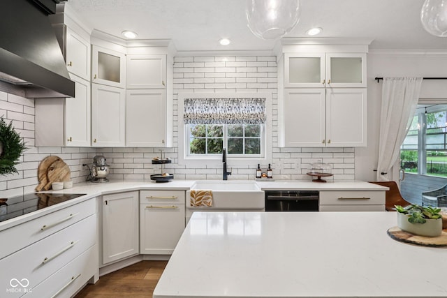 1345 Lewiston Dr, Westfield, IN 46074 - kitchen featuring dishwashing machine, wall chimney exhaust hood, decorative backsplash, black electric cooktop, and crown molding