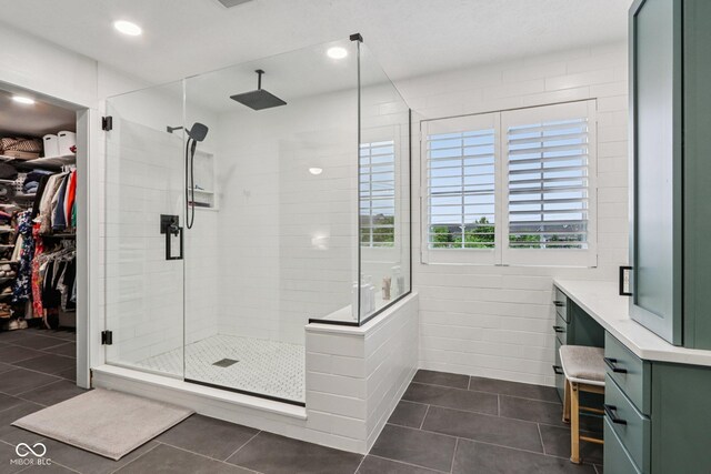 1345 Lewiston Dr, Westfield, IN 46074 - full bathroom featuring a stall shower, tile patterned floors, a walk in closet, and recessed lighting