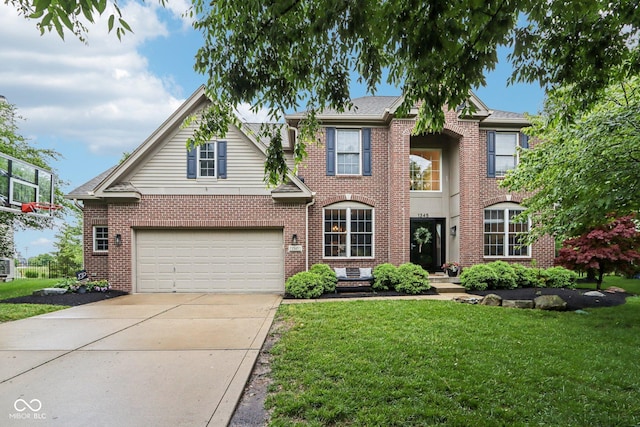 1345 Lewiston Dr, Westfield, IN 46074 - view of front facade with a garage, driveway, a front yard, and brick siding