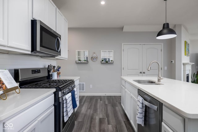 14110 Bay Willow Dr, Fishers, IN 46037 - kitchen with appliances with stainless steel finishes, light countertops, dark wood-type flooring, decorative backsplash, and white cabinets