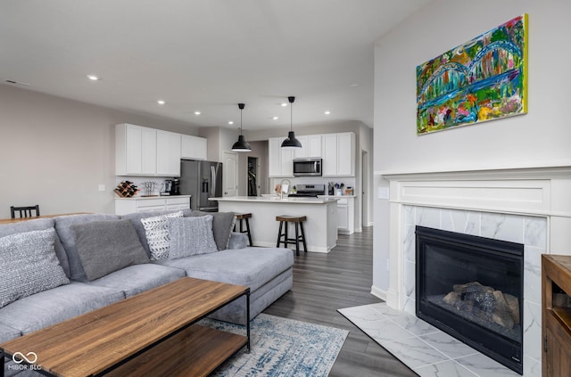 14110 Bay Willow Dr, Fishers, IN 46037 - living area with recessed lighting, wood finished floors, and a tile fireplace