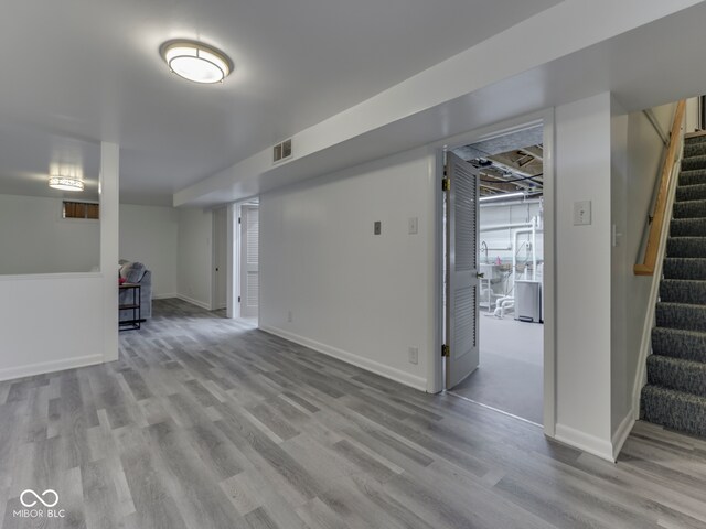 1504 Mcclure Rd, Columbus, IN 47201 - finished below grade area featuring stairway, wood finished floors, and baseboards