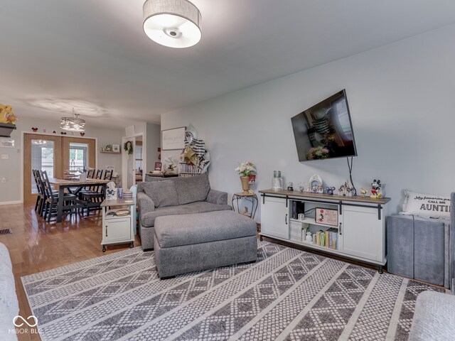 1504 Mcclure Rd, Columbus, IN 47201 - living area featuring light wood finished floors and a chandelier