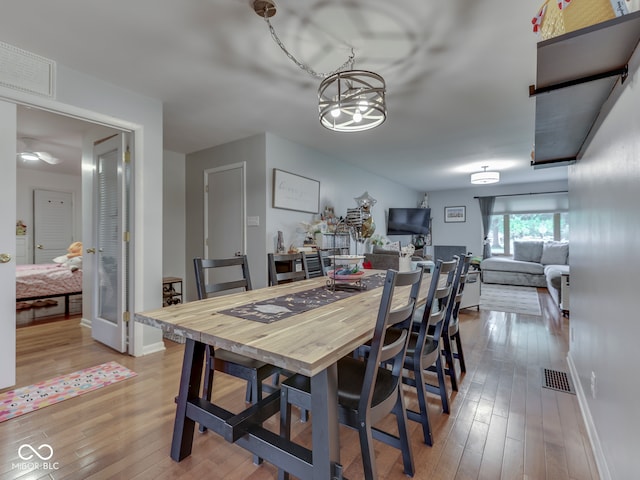 1504 Mcclure Rd, Columbus, IN 47201 - dining area with hardwood / wood-style floors, a chandelier, and baseboards
