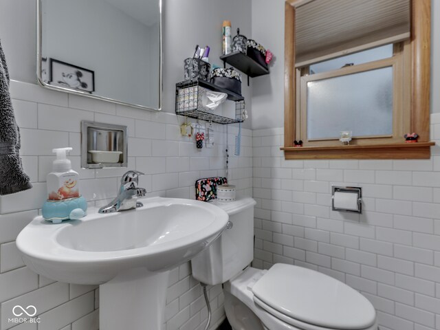 1504 Mcclure Rd, Columbus, IN 47201 - bathroom featuring tile walls, toilet, and wainscoting