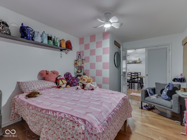 1504 Mcclure Rd, Columbus, IN 47201 - bedroom featuring wood finished floors, an accent wall, and ceiling fan