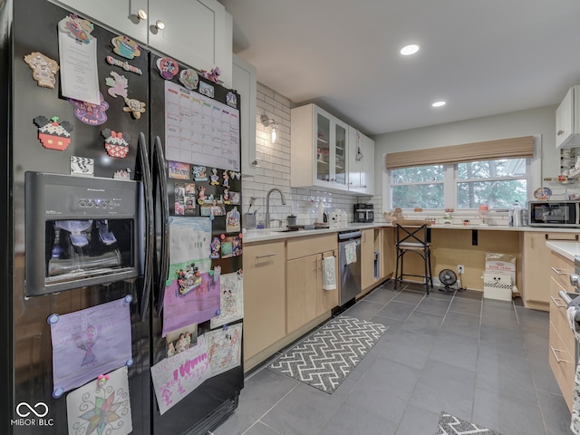 1504 Mcclure Rd, Columbus, IN 47201 - kitchen with stainless steel appliances, a sink, backsplash, light countertops, and recessed lighting
