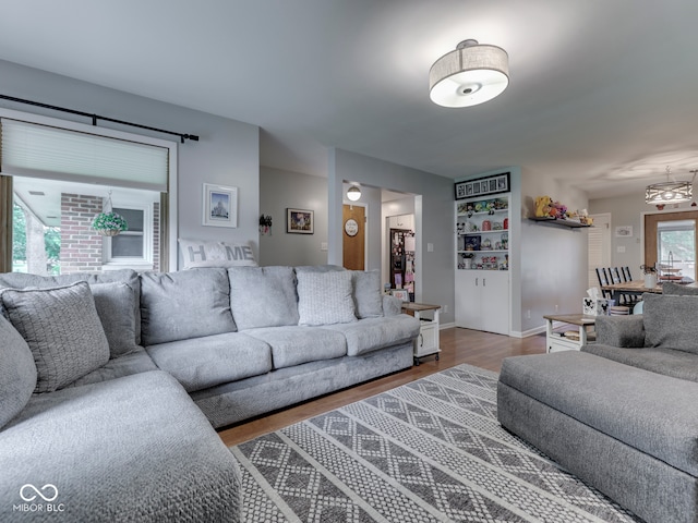 1504 Mcclure Rd, Columbus, IN 47201 - living area featuring wood finished floors, baseboards, and a chandelier