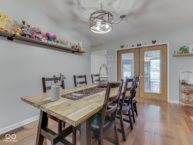 1504 Mcclure Rd, Columbus, IN 47201 - dining room with a chandelier, wood-type flooring, and baseboards