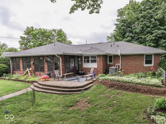 1504 Mcclure Rd, Columbus, IN 47201 - rear view of property with a sunroom, brick siding, a yard, and roof with shingles