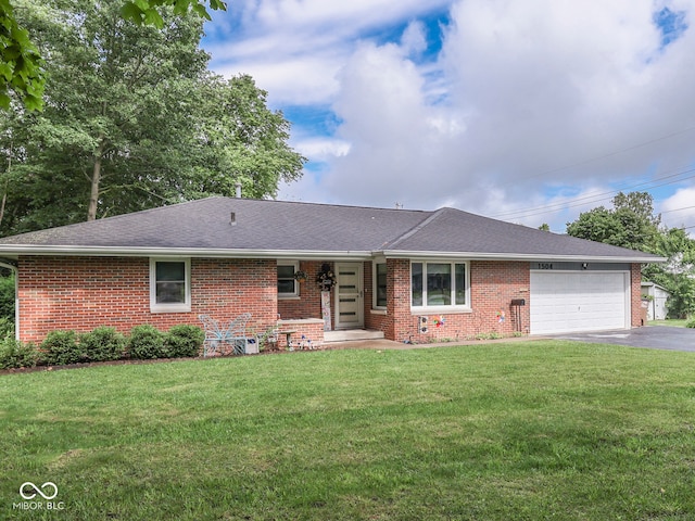 1504 Mcclure Rd, Columbus, IN 47201 - ranch-style house with brick siding, a garage, asphalt driveway, and a front lawn