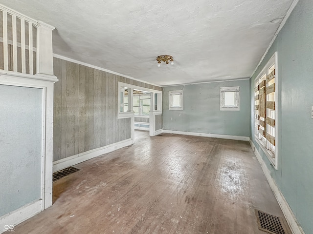 4709 E New York St, Indianapolis, IN 46201 - unfurnished living room featuring wood finished floors, baseboards, and crown molding