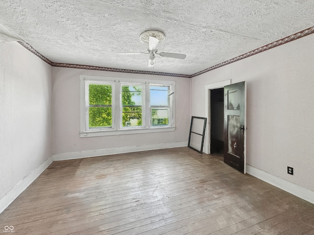 4709 E New York St, Indianapolis, IN 46201 - spare room with hardwood / wood-style flooring, crown molding, a ceiling fan, baseboards, and a textured ceiling