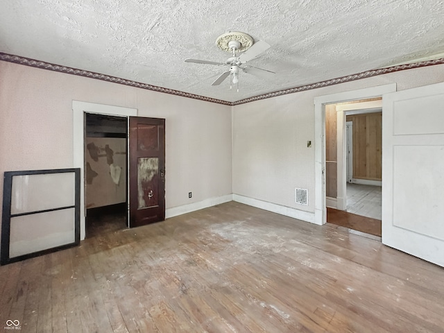 4709 E New York St, Indianapolis, IN 46201 - empty room featuring ceiling fan, wood-type flooring, crown molding, a textured ceiling, and baseboards