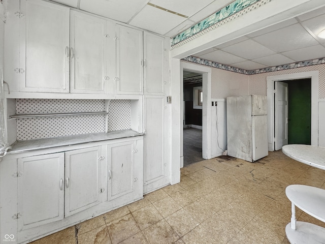 4709 E New York St, Indianapolis, IN 46201 - unfurnished dining area featuring a drop ceiling and light flooring