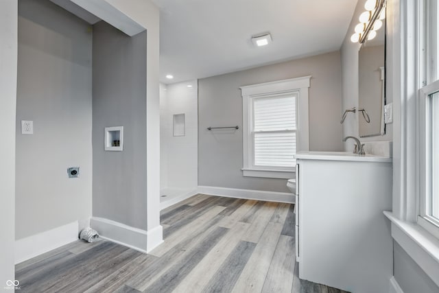 2896 Sutherland Ave, Indianapolis, IN 46205 - full bath with toilet, vanity, a tile shower, wood finished floors, and recessed lighting