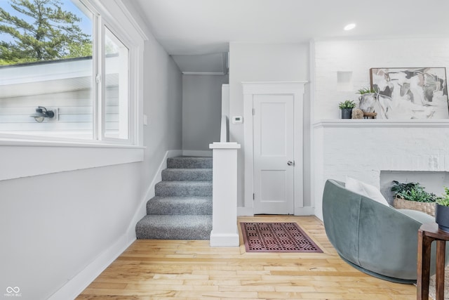 2896 Sutherland Ave, Indianapolis, IN 46205 - staircase with baseboards, wood finished floors, recessed lighting, and a fireplace