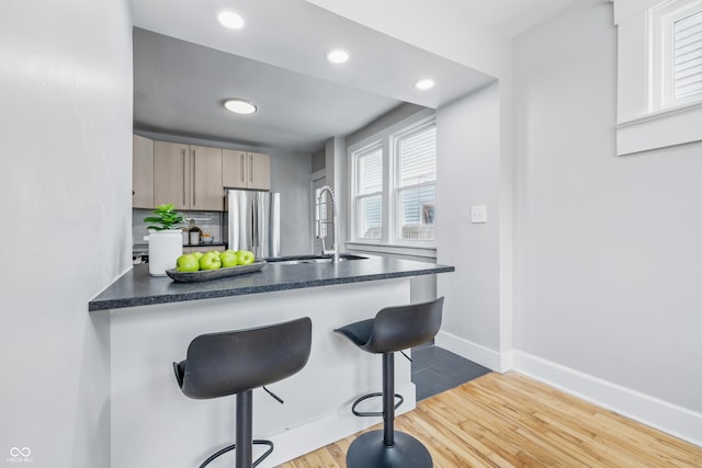 2896 Sutherland Ave, Indianapolis, IN 46205 - kitchen featuring freestanding refrigerator, a sink, dark countertops, recessed lighting, and baseboards