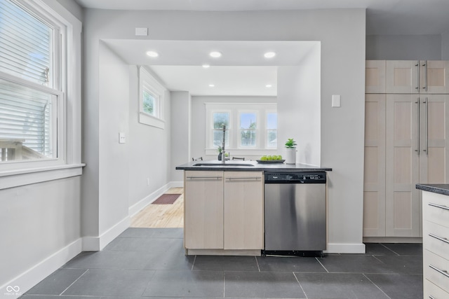 2896 Sutherland Ave, Indianapolis, IN 46205 - kitchen featuring dishwasher, a sink, dark tile patterned flooring, baseboards, and recessed lighting