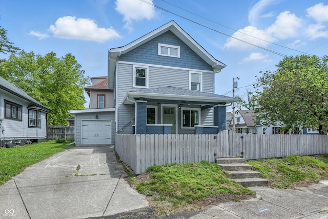 2896 Sutherland Ave, Indianapolis, IN 46205 - american foursquare style home featuring covered porch, driveway, a fenced front yard, and a garage