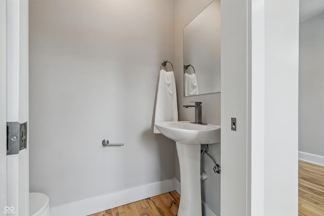 2896 Sutherland Ave, Indianapolis, IN 46205 - bathroom featuring baseboards, toilet, and wood finished floors