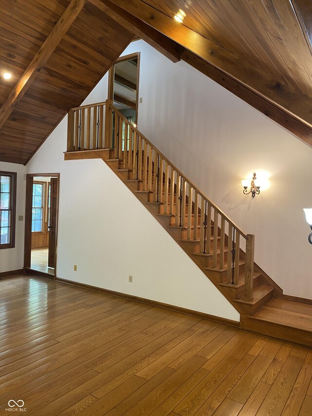 5530 Shawnee Trail S Drive, Indianapolis, IN 46220 - stairway featuring hardwood / wood-style flooring, wooden ceiling with exposed beams, high vaulted ceiling, and baseboards