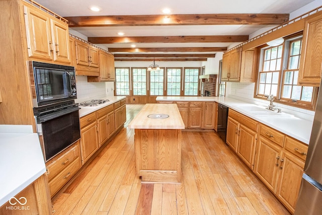 5530 Shawnee Trail S Drive, Indianapolis, IN 46220 - kitchen with black appliances, decorative backsplash, beam ceiling, light wood-style flooring, and a peninsula