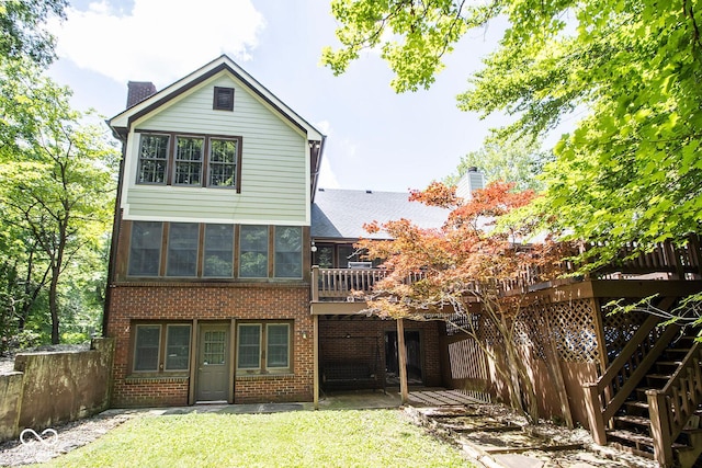 5530 Shawnee Trail S Drive, Indianapolis, IN 46220 - rear view of property with a chimney, brick siding, a lawn, a deck, and a patio