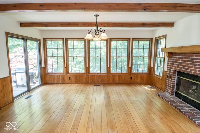 5530 Shawnee Trail S Drive, Indianapolis, IN 46220 - unfurnished living room with light wood-type flooring, a fireplace, beam ceiling, wooden walls, and a chandelier